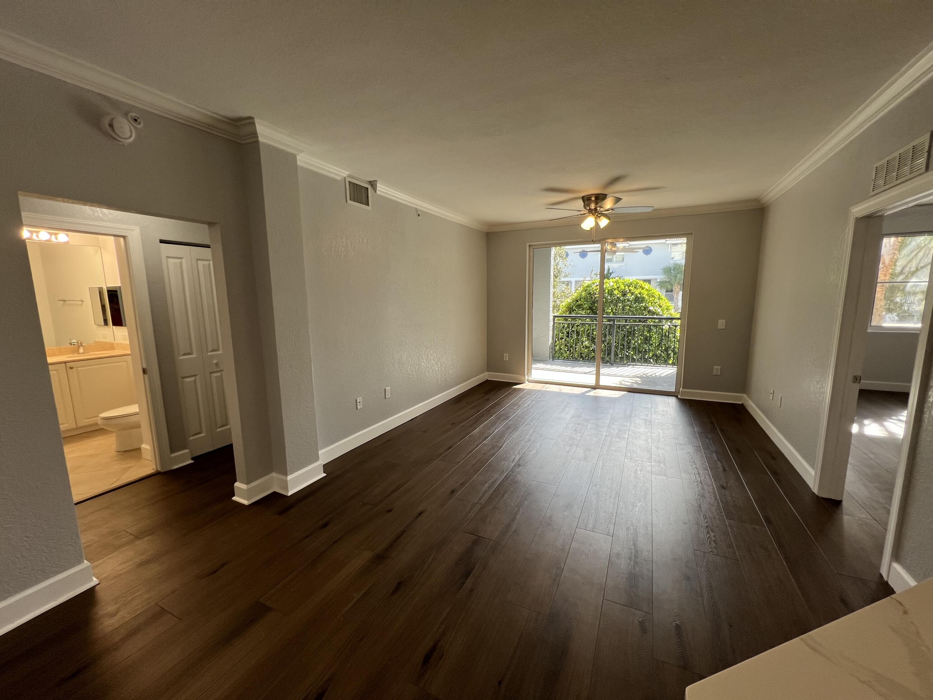 1660 Renaissance Commons Boulevard, Unit 2218 Boynton Beach, FL 33426 - Photo 14 of 23 an empty room with wooden floor and windows