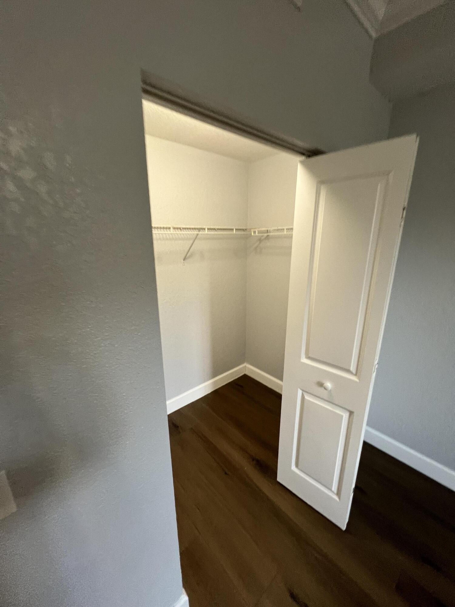 1660 Renaissance Commons Boulevard, Unit 2218 Boynton Beach, FL 33426 - Photo 16 of 23 a view of an empty room with wooden floor and a window