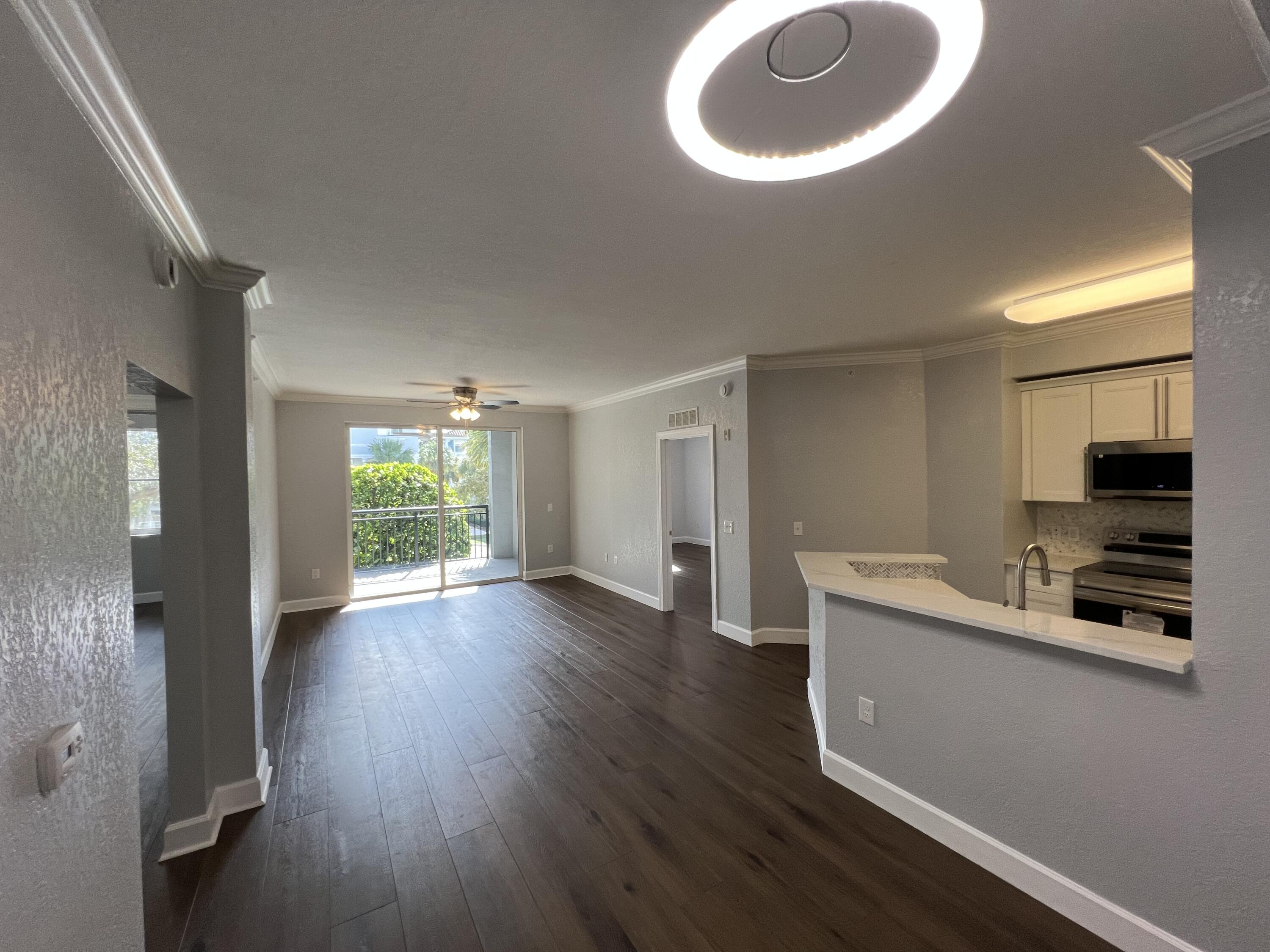 1660 Renaissance Commons Boulevard, Unit 2218 Boynton Beach, FL 33426 - Photo 23 of 23 wooden floor in an empty room with a window
