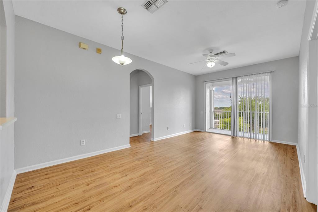 582 Brantley Terrace Way, Unit 304 Altamonte Springs, FL 32714 - Photo 9 of 30 a view of an empty room with wooden floor and a window