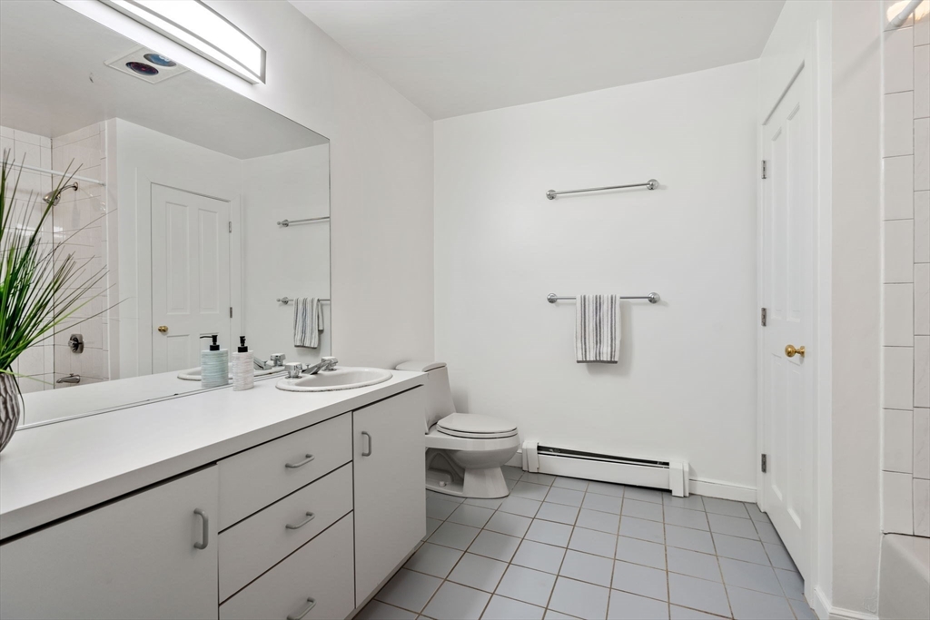 26 Bullard Road Weston, MA 02493 - Photo 25 of 31 a bathroom with a granite countertop sink a toilet and a mirror