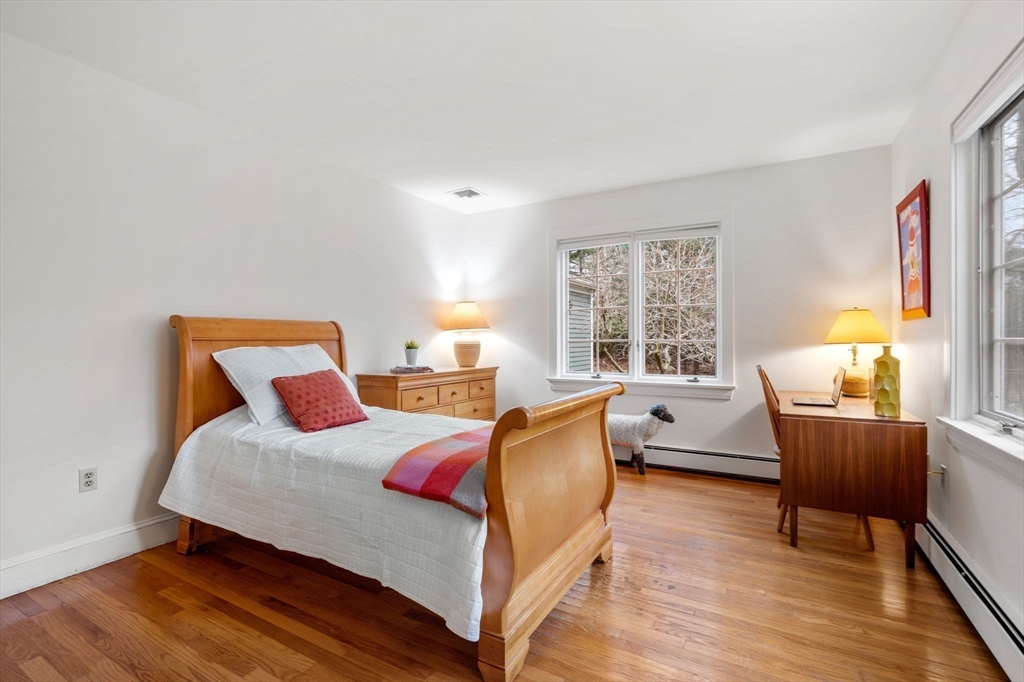 26 Bullard Road Weston, MA 02493 - Photo 26 of 31 a bedroom with a bed and wooden floor
