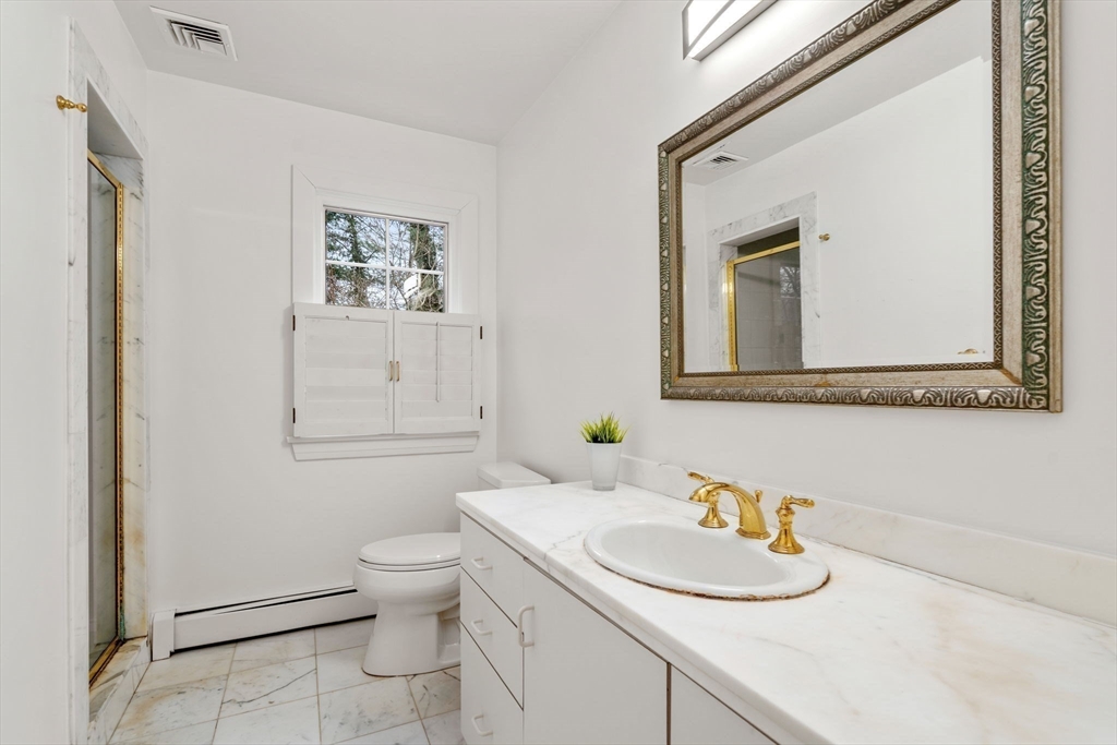 26 Bullard Road Weston, MA 02493 - Photo 28 of 31 a bathroom with a granite countertop sink mirror and toilet