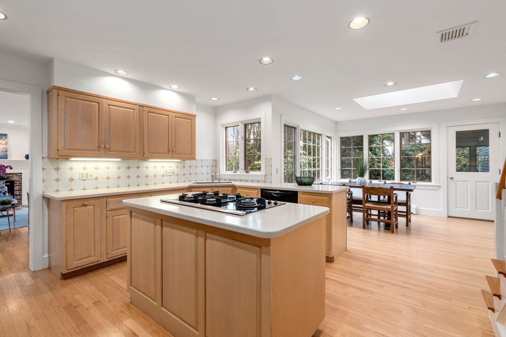 26 Bullard Road Weston, MA 02493 - Photo 10 of 31 a kitchen with stainless steel appliances granite countertop wooden cabinets a stove a sink a dining table and chairs