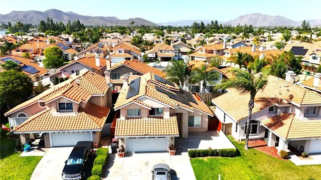an aerial view of a residential apartment building with a yard