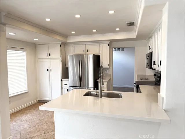 a kitchen with stainless steel appliances a refrigerator stove microwave and sink
