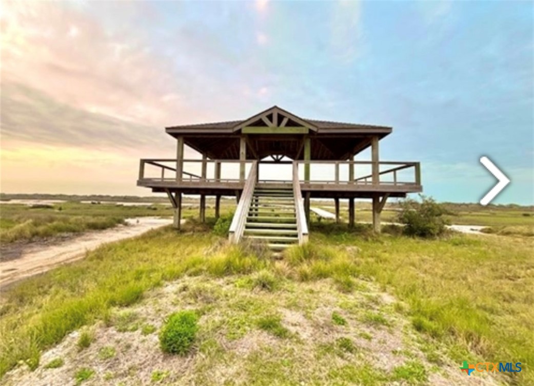 12 Easy Street Port O'Connor, TX 77982 - Photo 2 of 18 a view of a swimming pool with a table and chairs