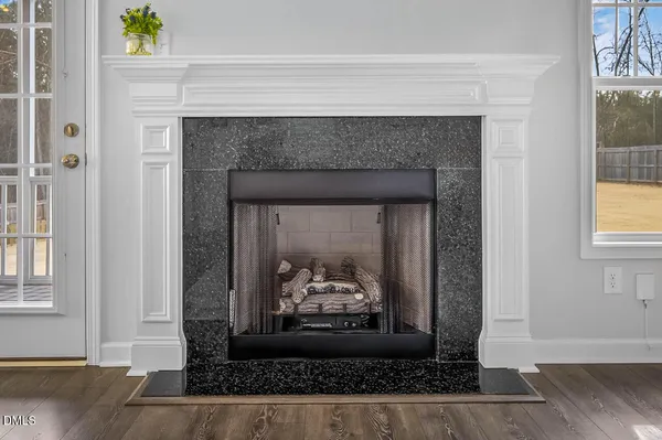 a bedroom with a bed lamp and a window