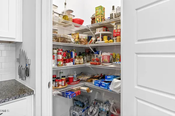 a view of walk in closet with clothes