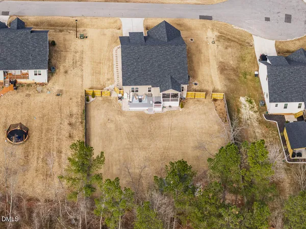 a kitchen with granite countertop a stove and a living room