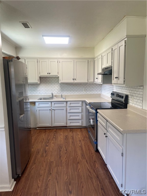 1302 Andover Road Henrico, VA 23229 - Photo 4 of 15 a kitchen with wooden floors white cabinets and stainless steel appliances