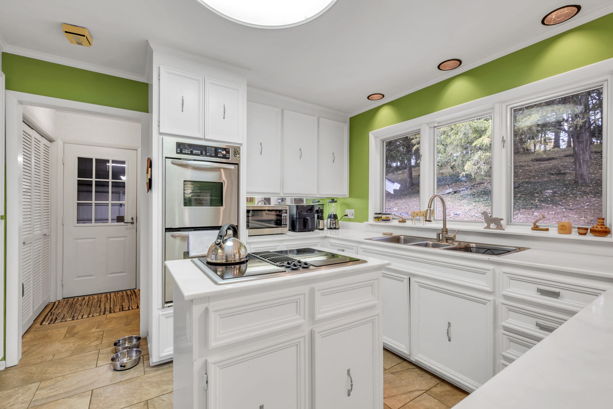 1524 Cherokee Road Gallatin, TN 37066 - Photo 28 of 65 a kitchen with stainless steel appliances granite countertop a stove a sink and a granite counter tops with white cabinets