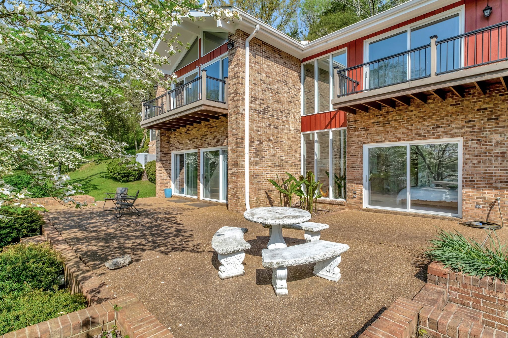 1524 Cherokee Road Gallatin, TN 37066 - Photo 51 of 65 a view of a brick house with chairs and floor to ceiling window