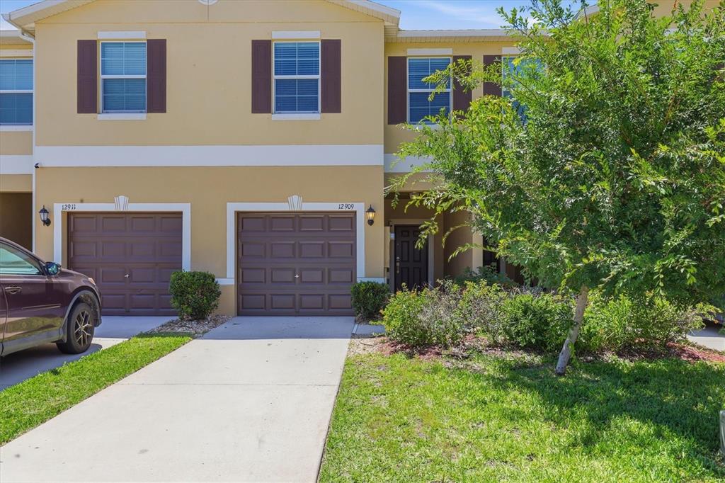 12909 Dream Catcher Way Riverview, FL 33579 - Photo 3 of 32 a front view of a house with garden