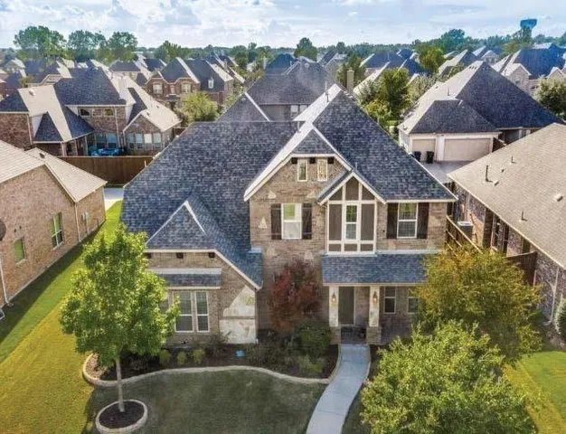 an aerial view of a house with a yard