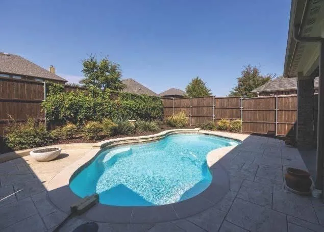 a view of a swimming pool with a yard