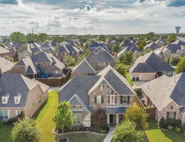 an aerial view of residential houses with outdoor space