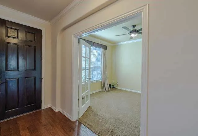 an entryway and a livingroom with wooden floor