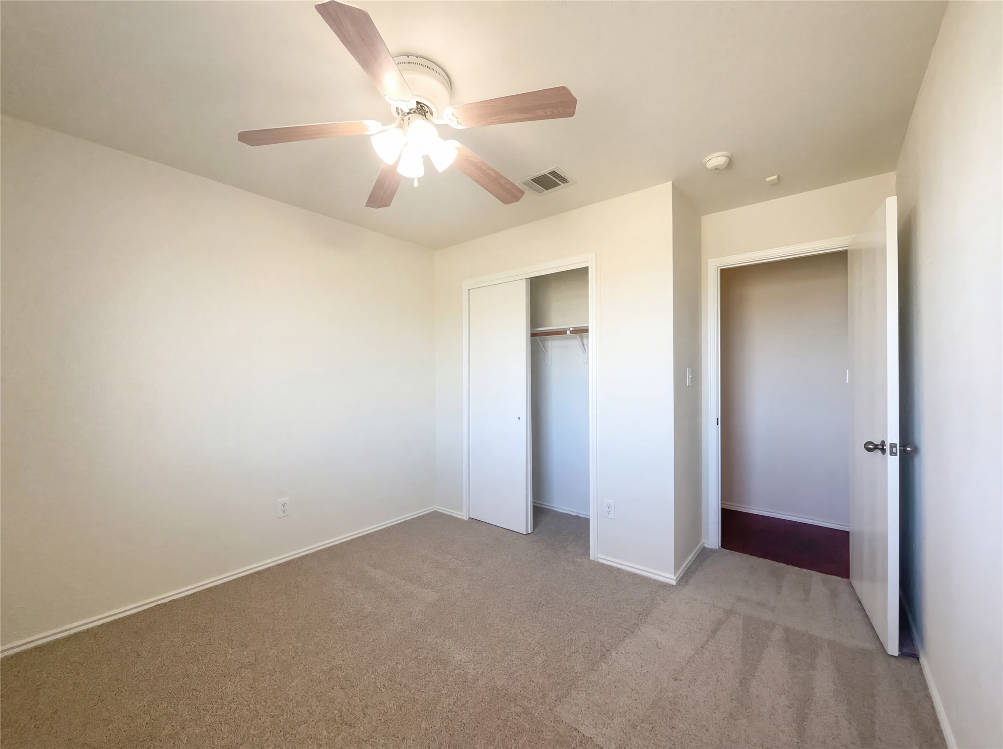 15305 Lucian Street Austin, TX 78725 - Photo 12 of 25 an empty room with a chandelier fan and closet area