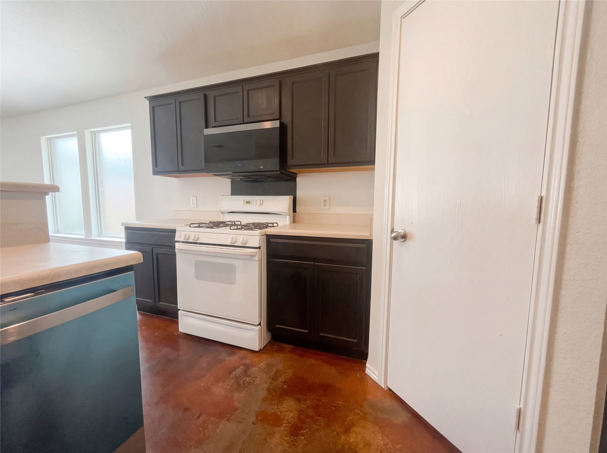 15305 Lucian Street Austin, TX 78725 - Photo 2 of 25 a kitchen with a sink stove and microwave