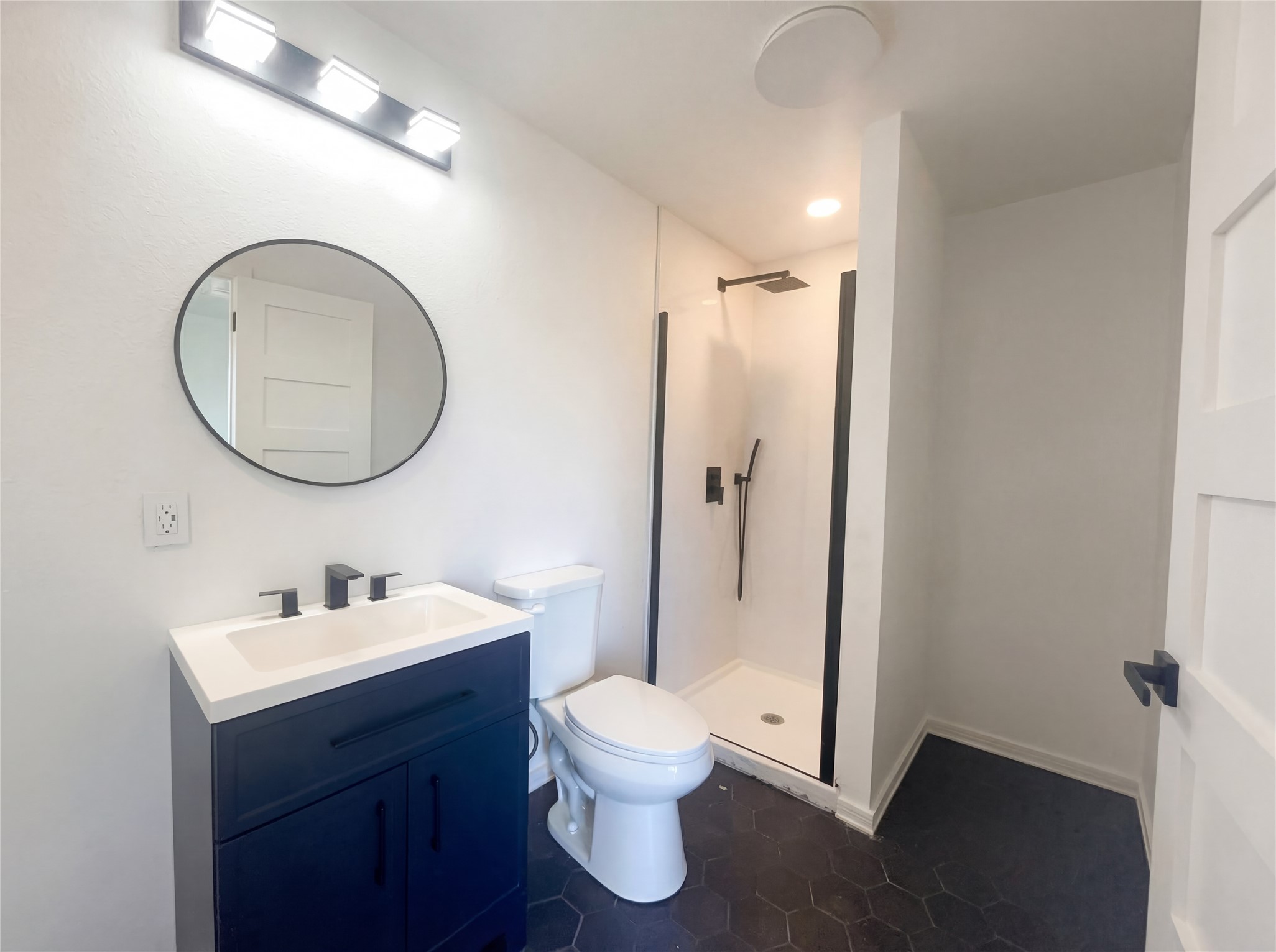 15305 Lucian Street Austin, TX 78725 - Photo 21 of 25 a bathroom with a toilet sink and shower