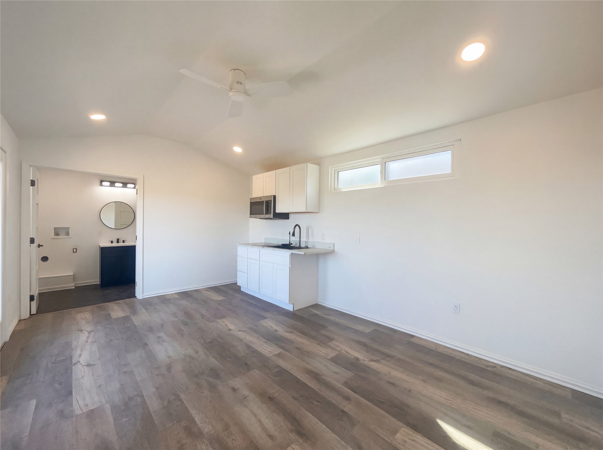 15305 Lucian Street Austin, TX 78725 - Photo 22 of 25 a view of a kitchen with a sink and a refrigerator