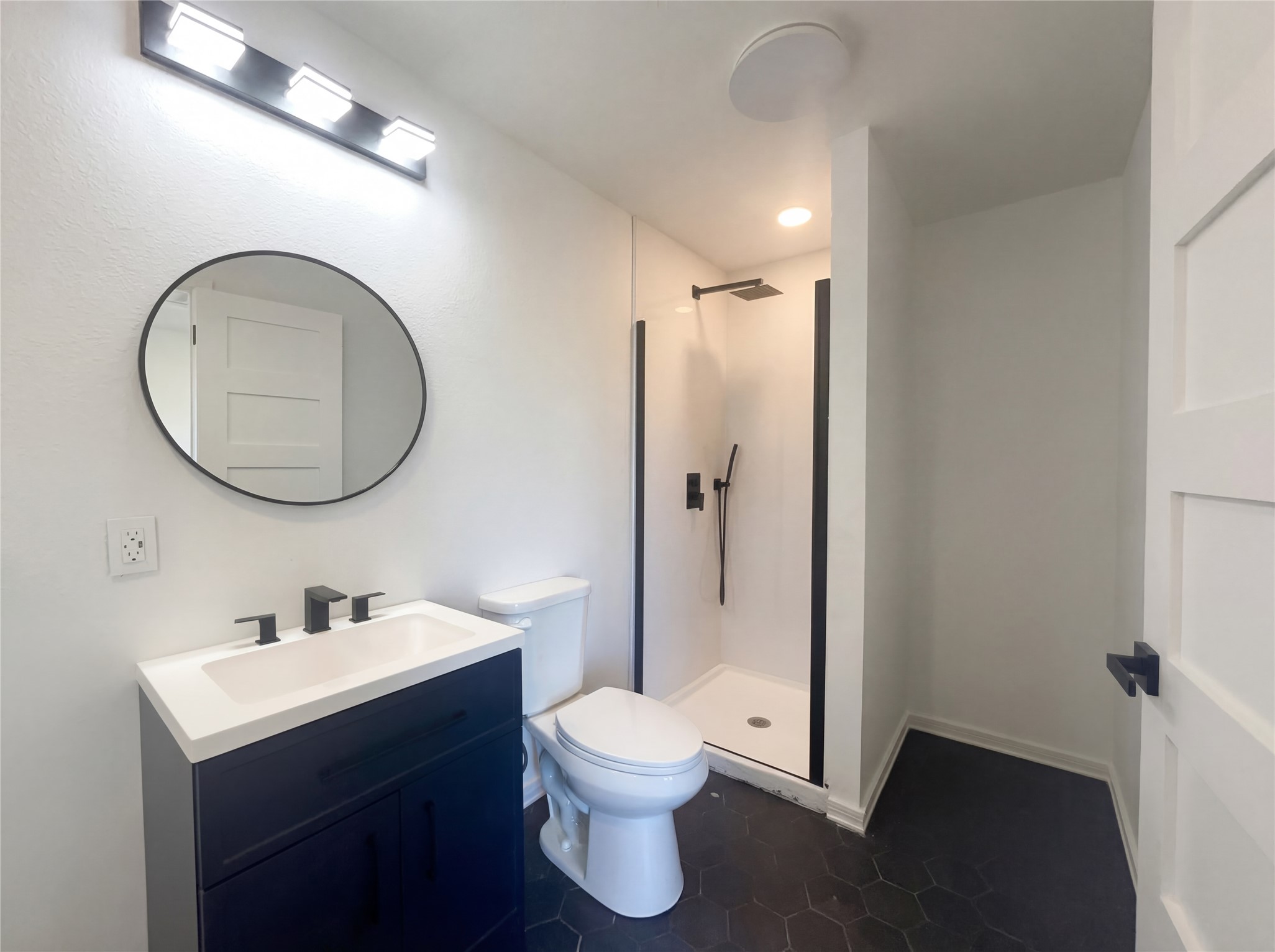 15305 Lucian Street Austin, TX 78725 - Photo 24 of 25 a bathroom with a toilet a sink and a mirror