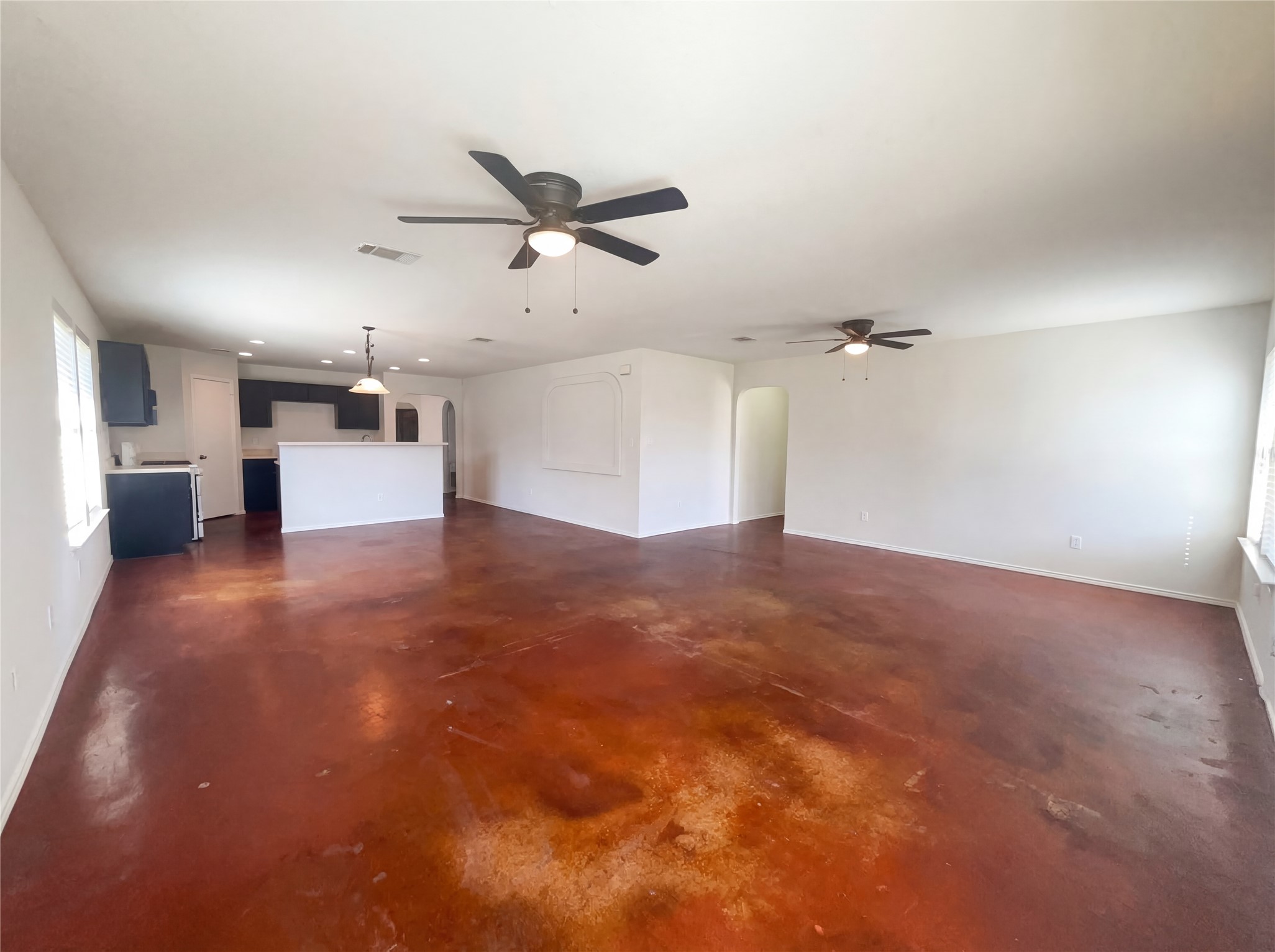 15305 Lucian Street Austin, TX 78725 - Photo 3 of 25 a view of a big room with wooden floor and windows