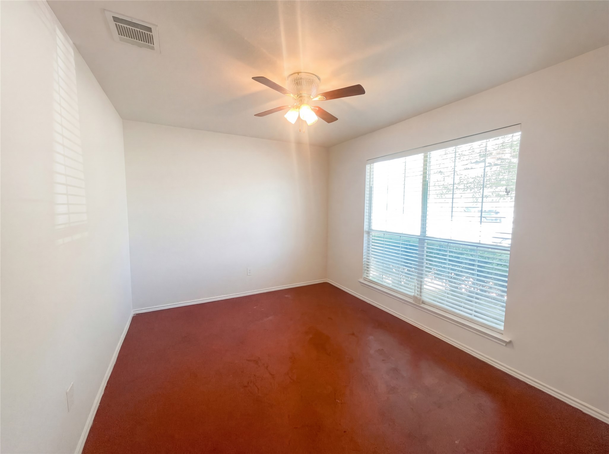 15305 Lucian Street Austin, TX 78725 - Photo 8 of 25 an empty room with windows and fan