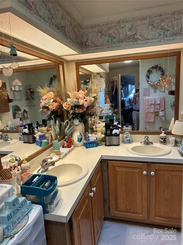 a room with lots of flowers and lots of frames on wall