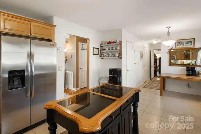 a kitchen with stainless steel appliances granite countertop a refrigerator a sink and a stove