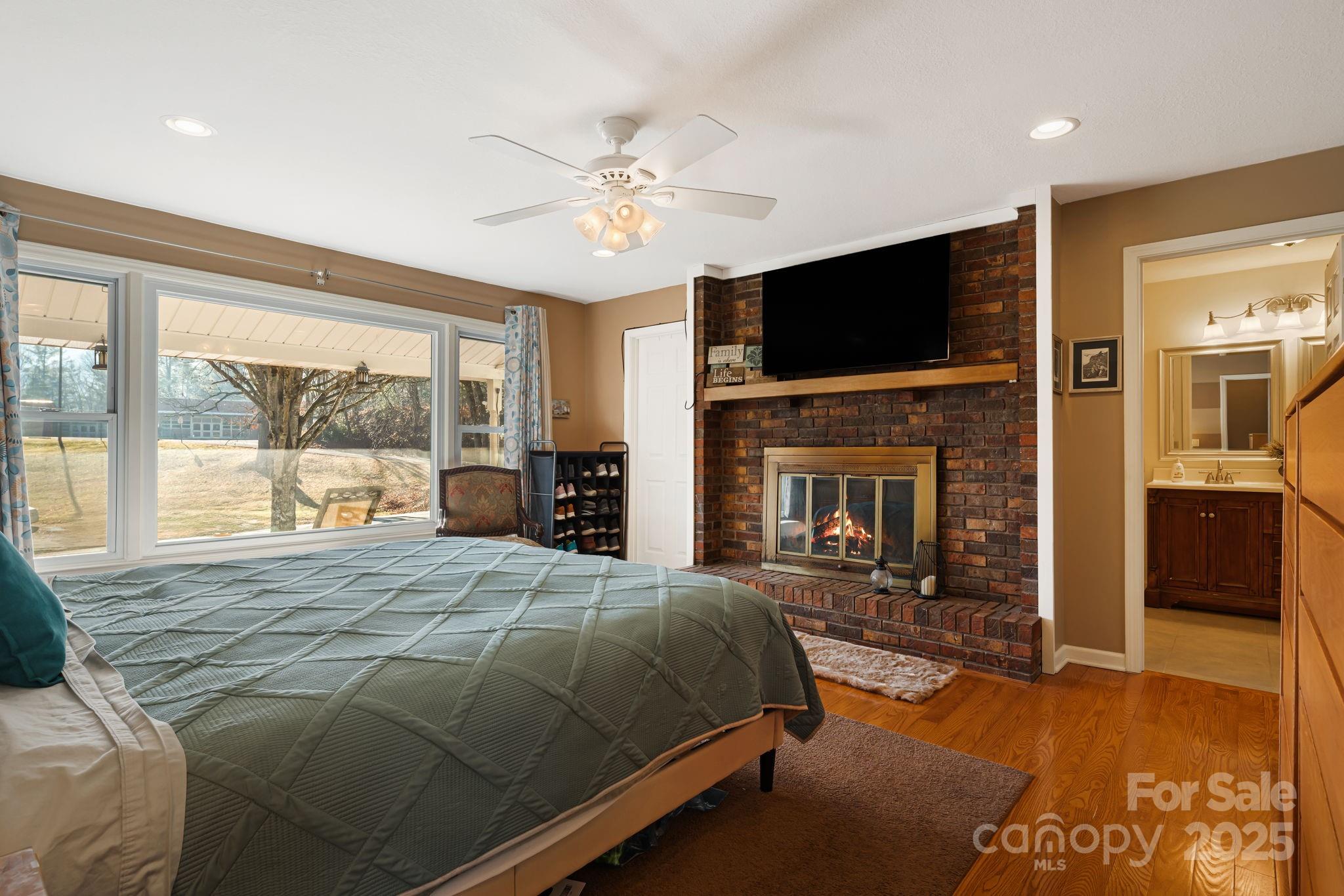 154 Harris Street Spruce Pine, NC 28777 - Photo 18 of 37 a bedroom with a bed and a flat screen tv