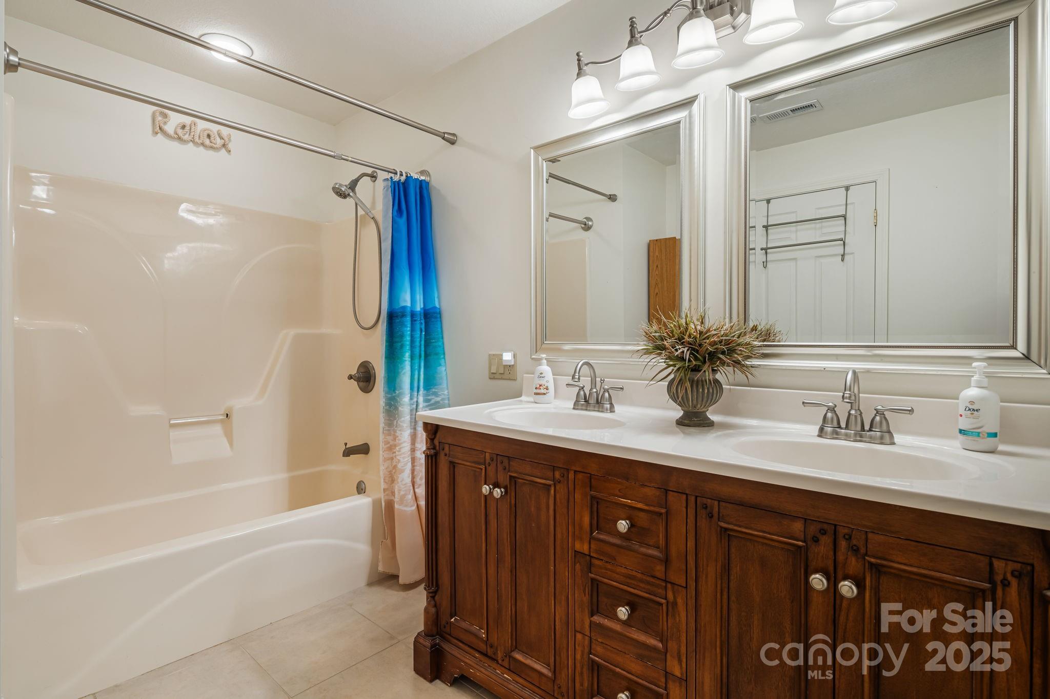 154 Harris Street Spruce Pine, NC 28777 - Photo 20 of 37 a bathroom with a sink double vanity granite tub shower and a mirror