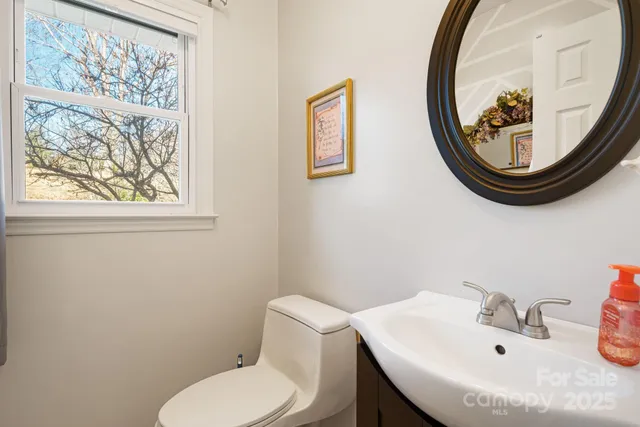 a bathroom with a toilet a sink and a mirror