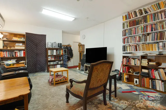 a living room with furniture and a book shelf