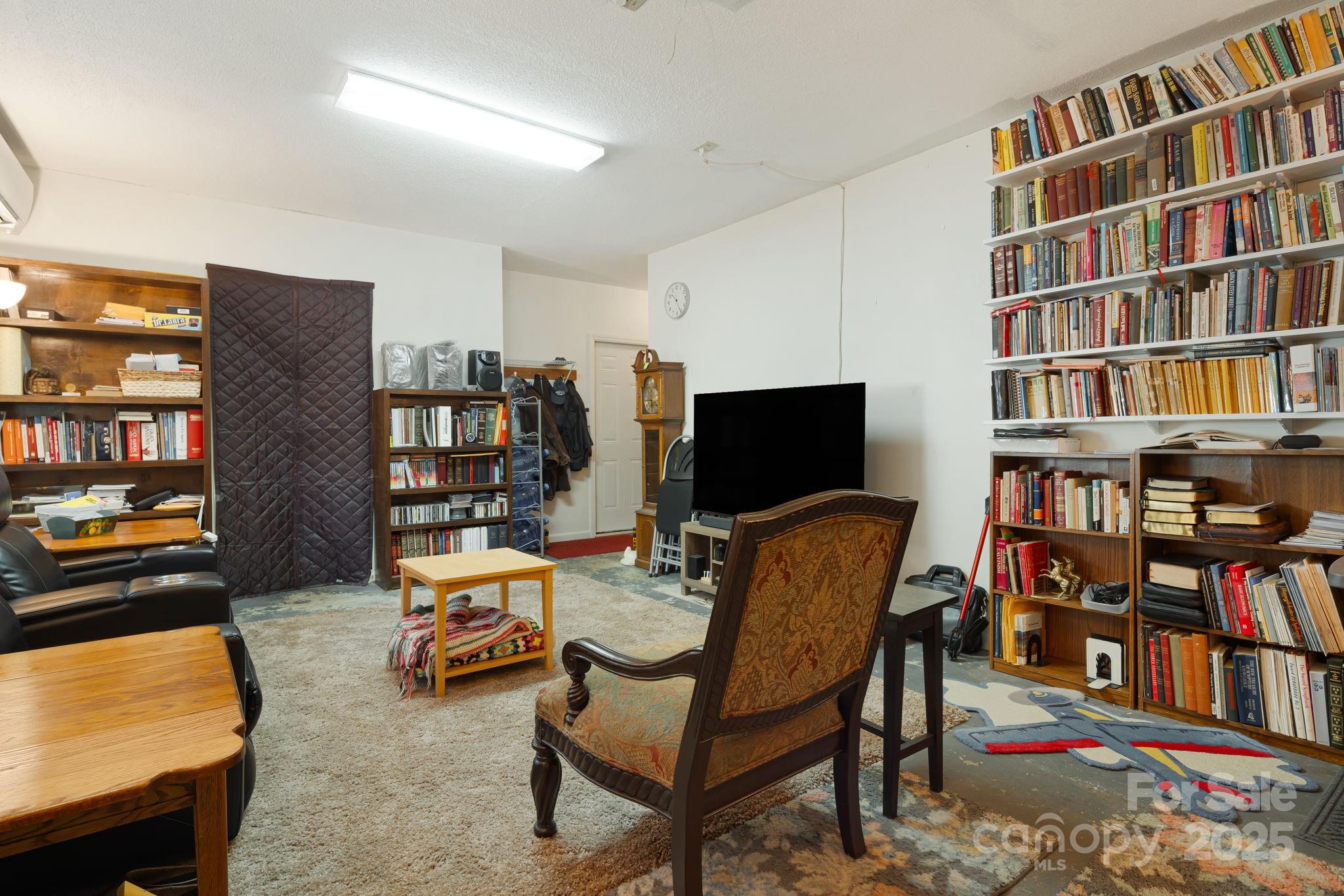 154 Harris Street Spruce Pine, NC 28777 - Photo 24 of 37 a living room with furniture and a book shelf