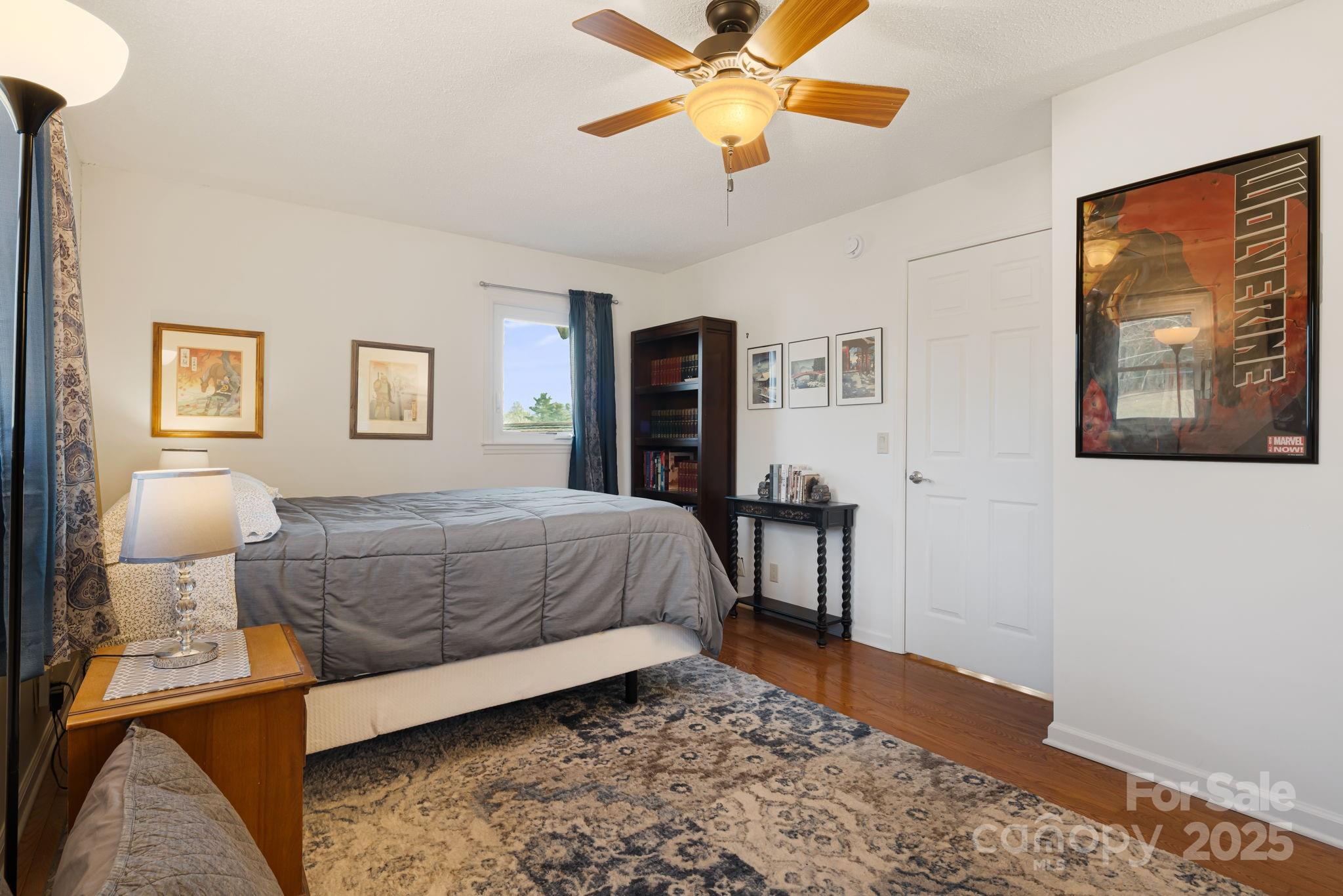 154 Harris Street Spruce Pine, NC 28777 - Photo 26 of 37 a bedroom with a bed and wooden floor