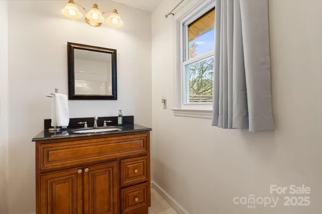 a bathroom with a sink a vanity and a window