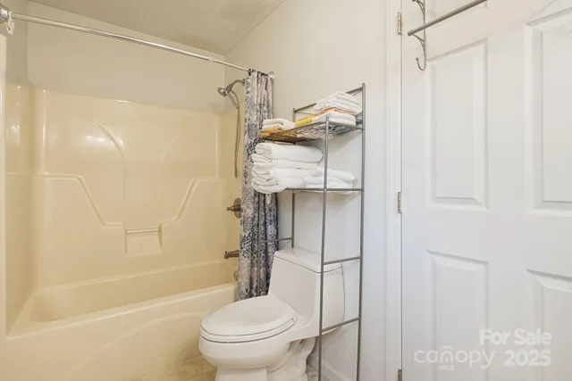 a bathroom with a shower a toilet and a shower