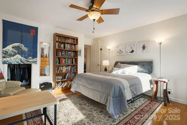 a bedroom with a bed and a chandelier