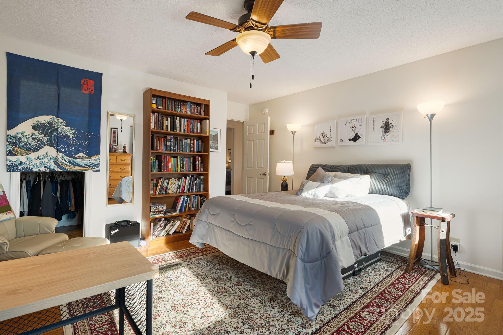 154 Harris Street Spruce Pine, NC 28777 - Photo 30 of 37 a bedroom with a bed and a chandelier