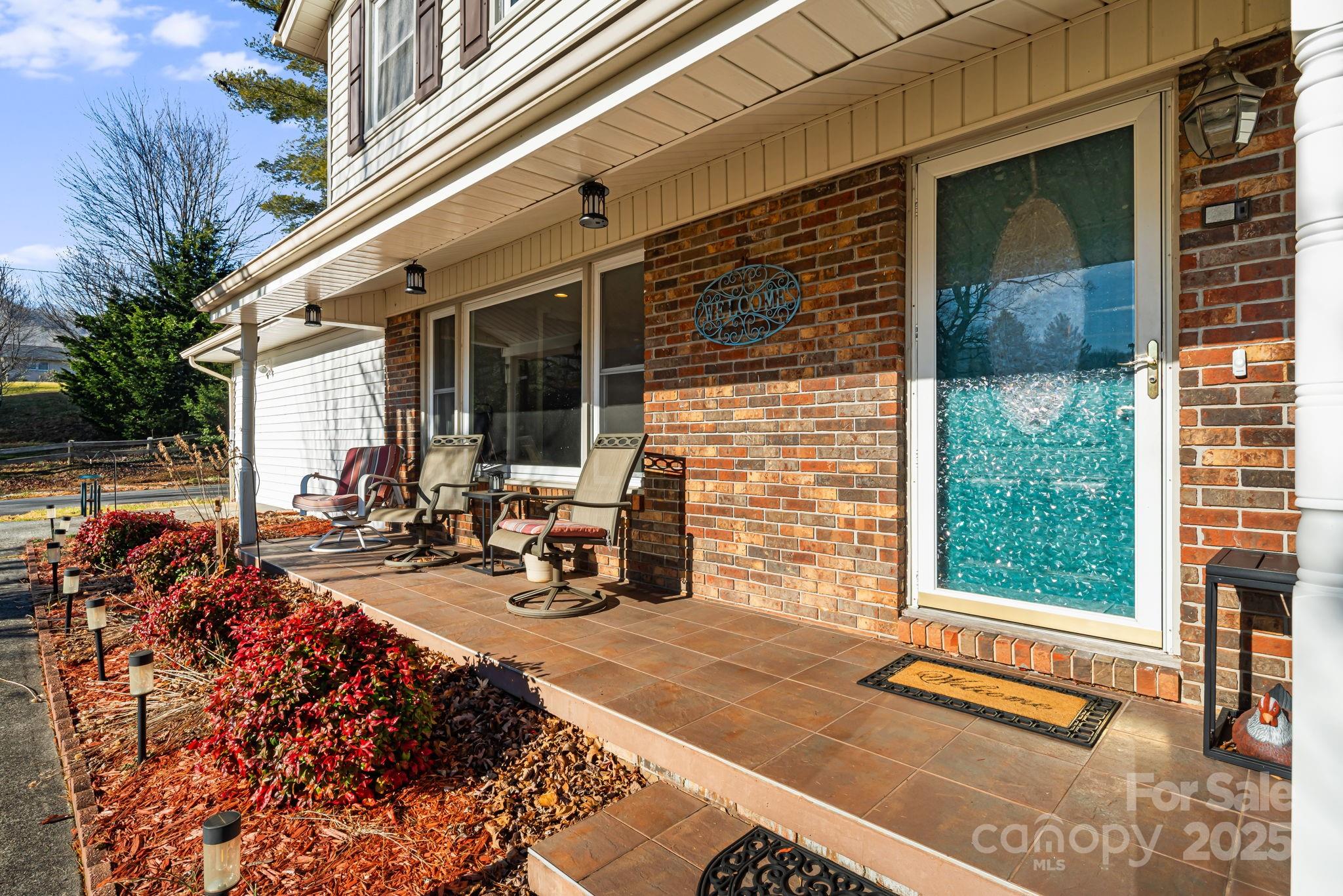 154 Harris Street Spruce Pine, NC 28777 - Photo 5 of 37 a view of a brick house with many windows and wooden fence