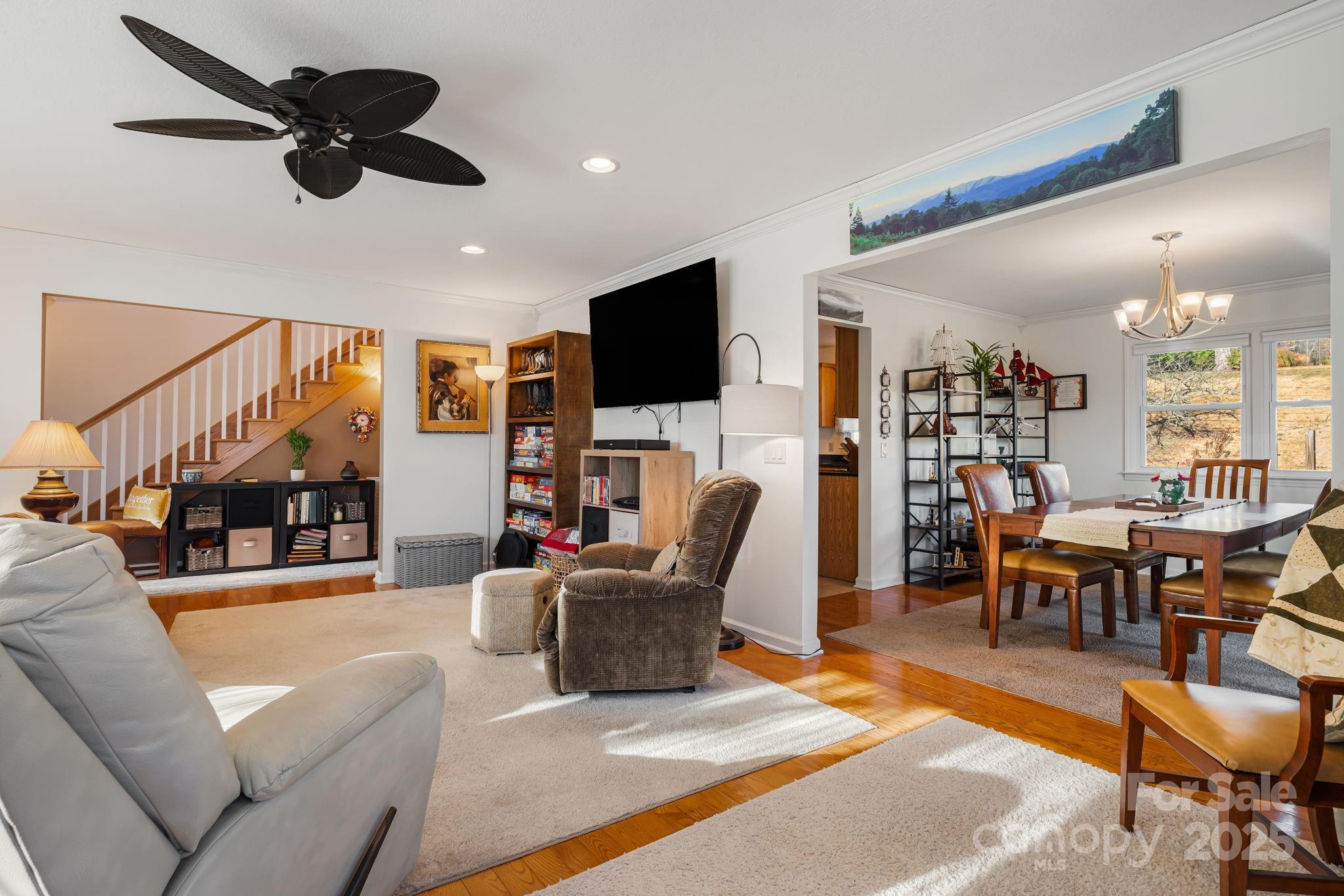 154 Harris Street Spruce Pine, NC 28777 - Photo 9 of 37 a living room with furniture a ceiling fan and a flat screen tv
