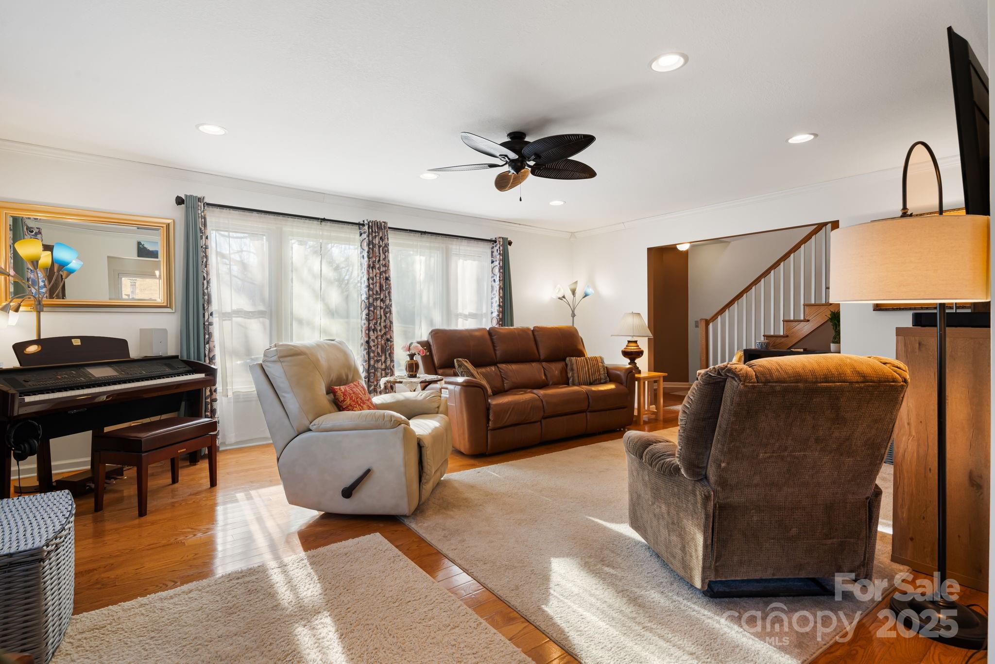 154 Harris Street Spruce Pine, NC 28777 - Photo 10 of 37 a living room with furniture a ceiling fan and a window