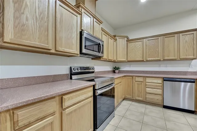 a kitchen with stainless steel appliances granite countertop a sink and a stove