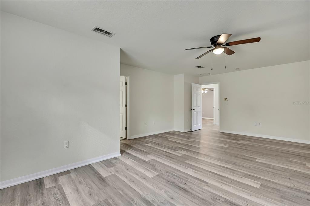 12052 Jade Avenue Spring Hill, FL 34609 - Photo 16 of 45 a view of empty room with wooden floor