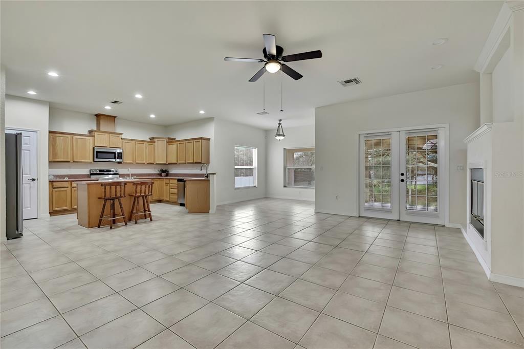 12052 Jade Avenue Spring Hill, FL 34609 - Photo 2 of 45 a kitchen with stainless steel appliances kitchen island granite countertop a refrigerator and a sink
