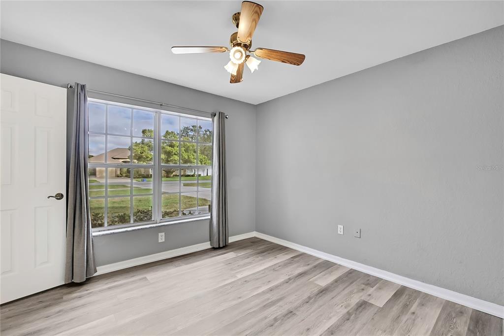 12052 Jade Avenue Spring Hill, FL 34609 - Photo 21 of 45 a view of an empty room with a window