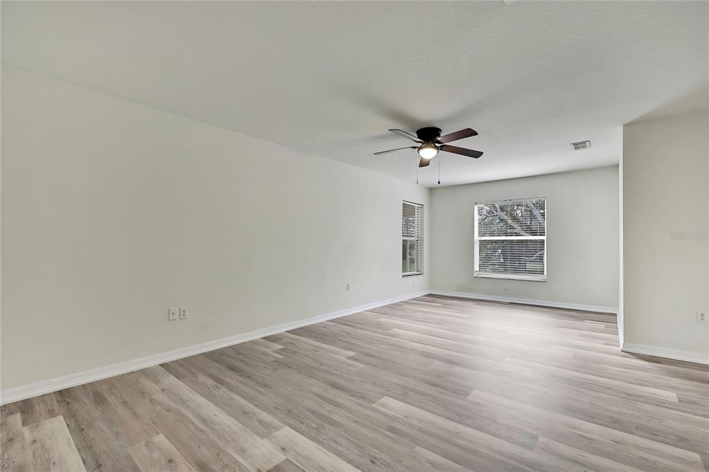 12052 Jade Avenue Spring Hill, FL 34609 - Photo 24 of 45 wooden floor in an empty room with a window