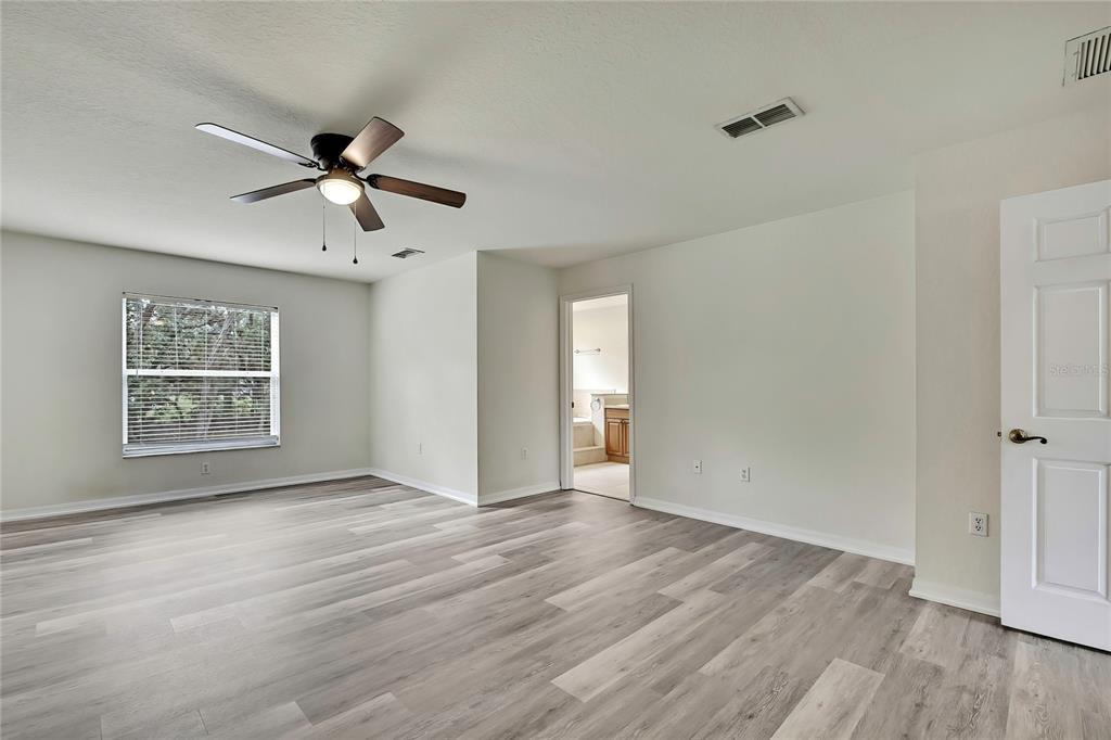 12052 Jade Avenue Spring Hill, FL 34609 - Photo 25 of 45 wooden floor in an empty room with a window